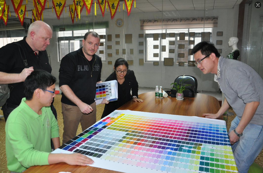 A handshake between a business professional and a designer, symbolizing a partnership, with premium golf wear designs and materials in the background